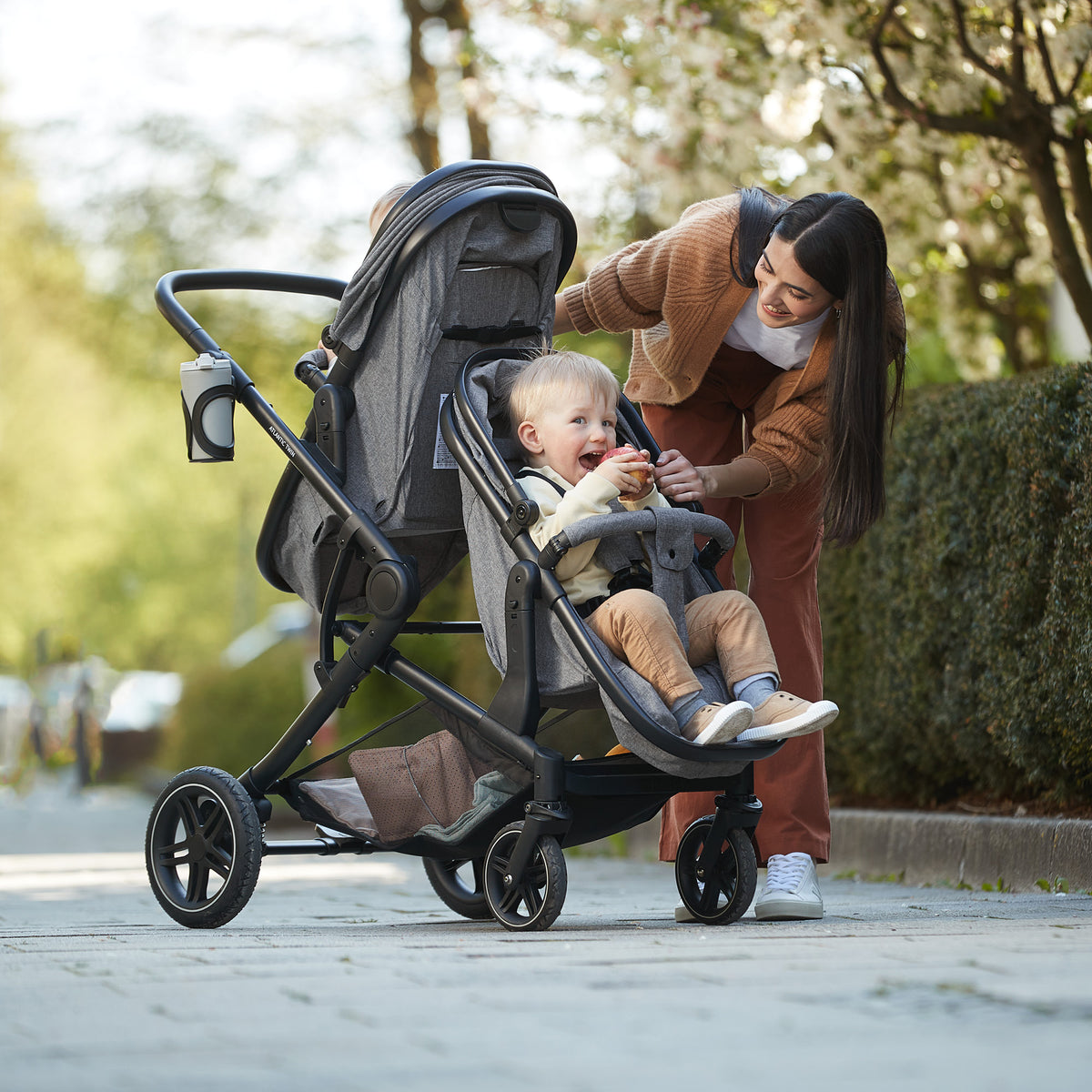 Mother with a toddler in the Hauck Atlantic Twin pushchair outdoors